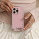 Person holding a pink phone case with heart designs 