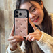Person holding a phone with a decorative case