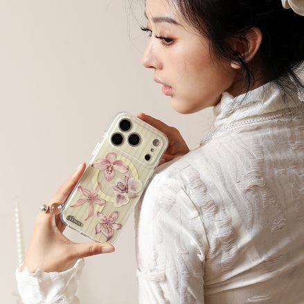 Woman holding a phone with a floral case