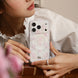Person holding a phone with a floral case