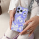 Person holding a phone with a purple bow pattern case