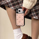 Person holding a phone with a decorative case