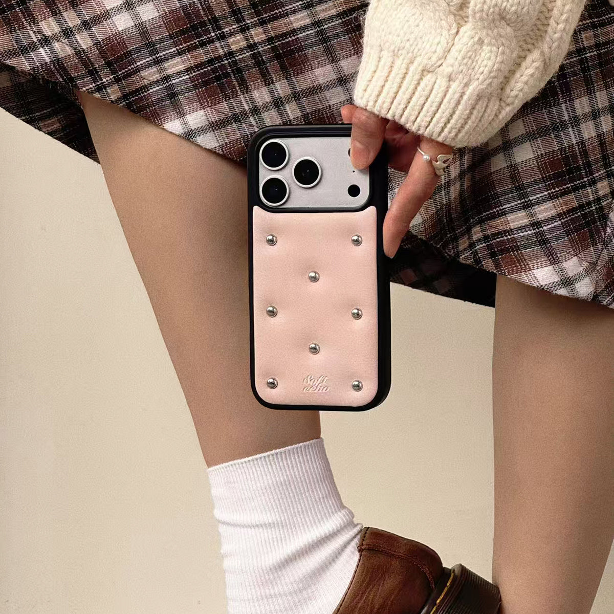 Person holding a phone with a decorative case