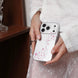 Person holding a phone with a star-patterned case in a neutral setting