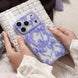 Phone case with blue ribbons held by hands on a textured surface