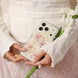 Person holding a phone with a floral case