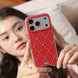 Person holding a red phone case with rhinestones
