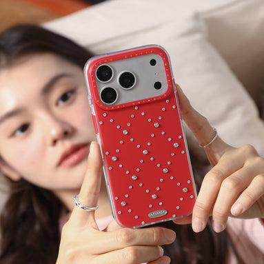 Person holding a red phone case with rhinestones