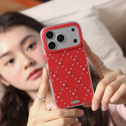 Person holding a red phone case with rhinestones