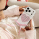 Person holding a white phone with a pink heart design and ribbon