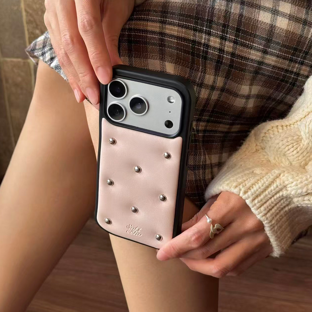 Person holding a phone with a decorative case