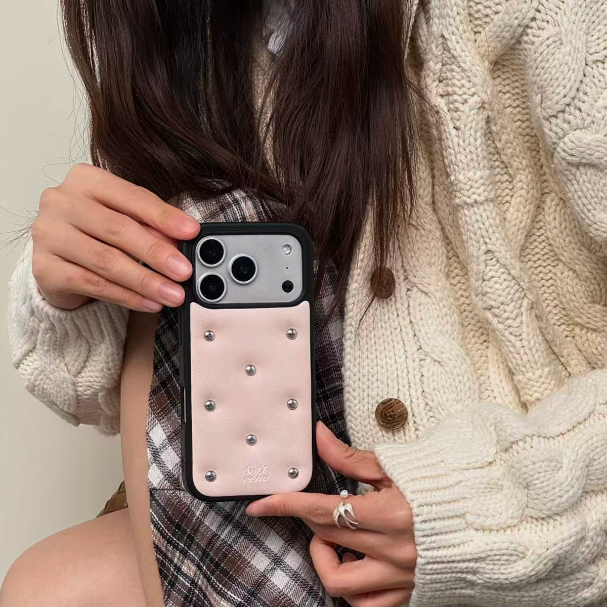 Person holding a phone case with decorative elements