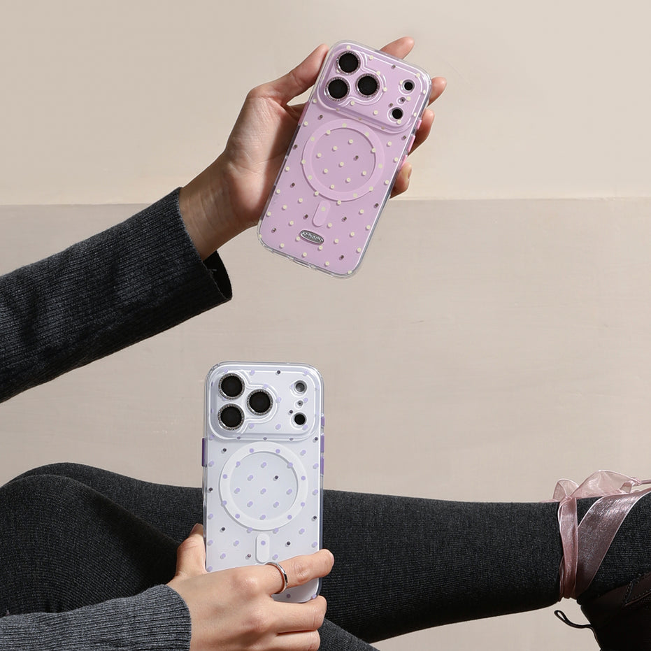 Two phone cases with circular designs held by a person against a beige background