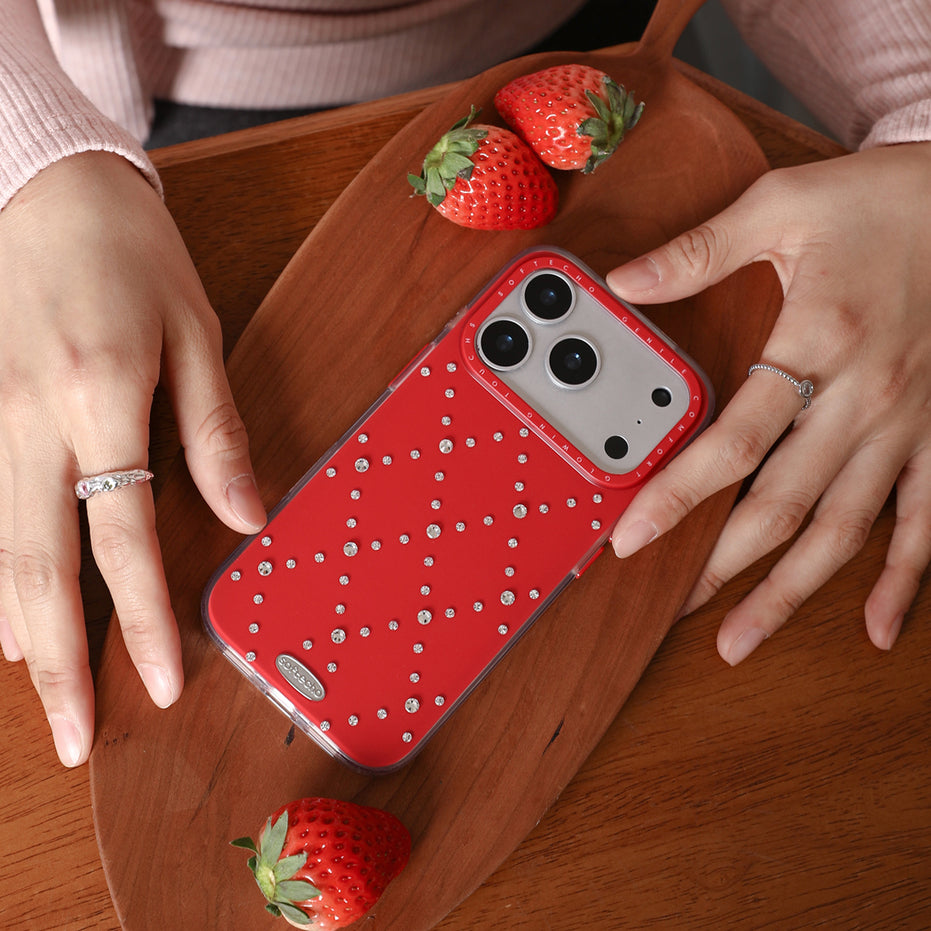 Red phone case with rhinestones on a wooden surface