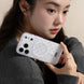 Person holding a phone case with a polka dot design