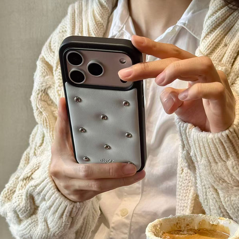 Person holding a phone with a decorative case