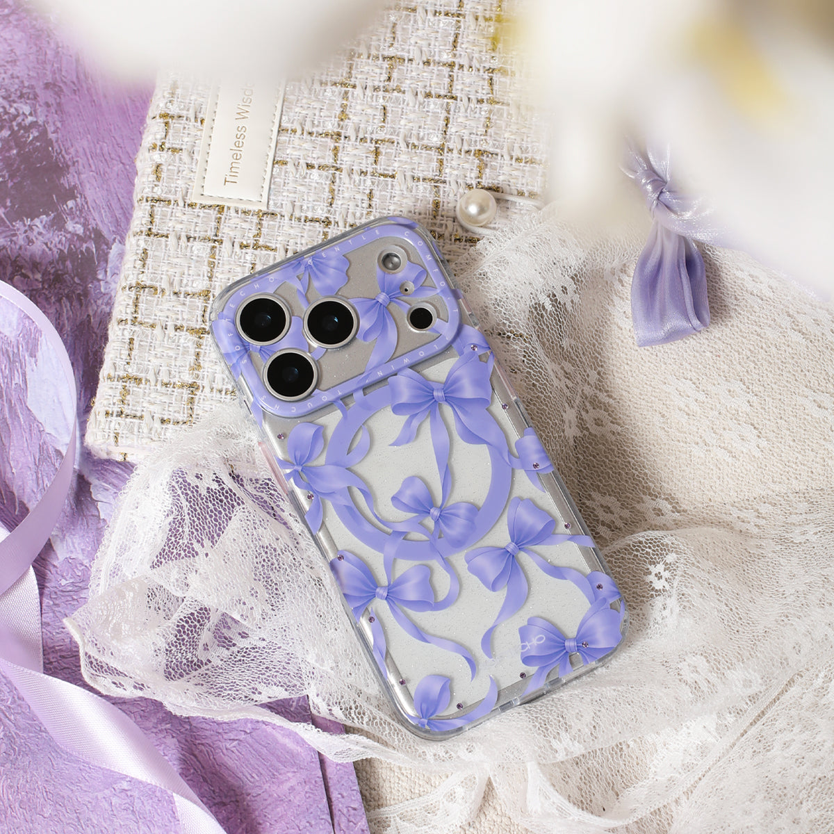 Phone case with purple bow design on a textured surface