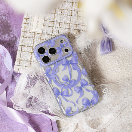 Phone case with purple bow design on a textured surface