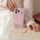 Pink phone case with decorative elements held by a person on a wooden surface.