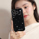 Woman holding a black phone case with decorative elements
