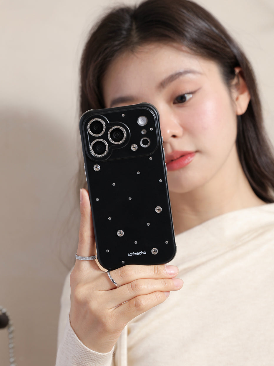 Woman holding a black phone case with decorative elements