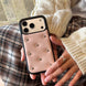 Person holding a phone with a pink case featuring studs