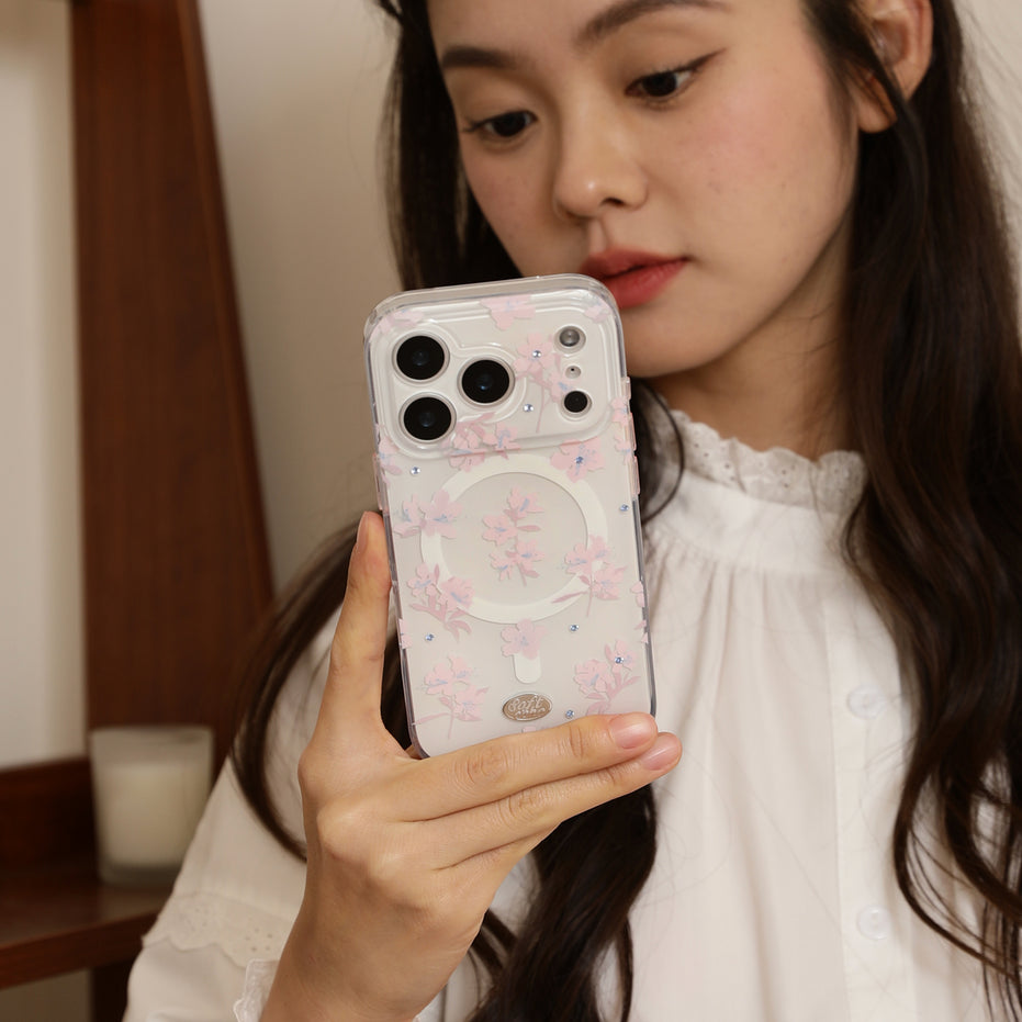 Person holding a phone with a floral case