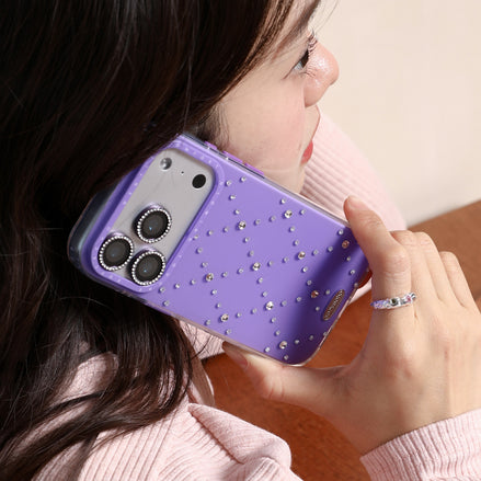 Person holding a purple phone case with rhinestone details