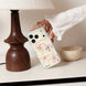 Person holding a phone with a floral case