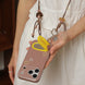 Person holding a phone case with a decorative strap