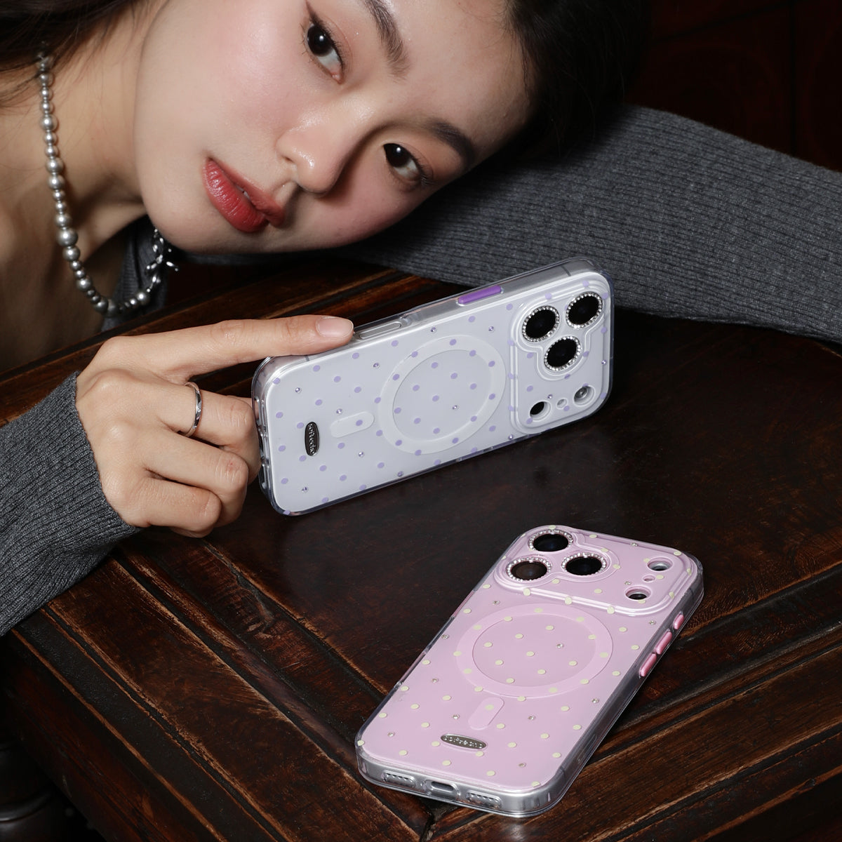 Person holding a phone case with another case on a table