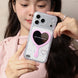 Person holding a phone case with a heart design and pink mirror.
