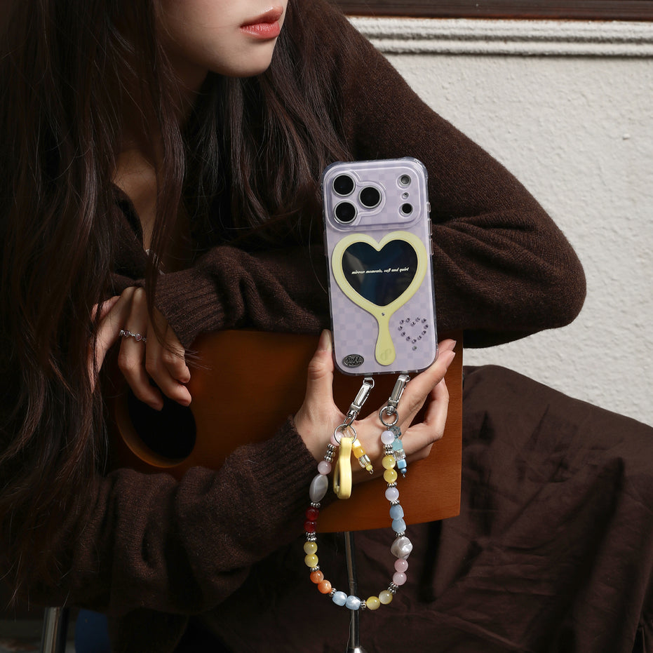 Person holding a phone with a heart design case