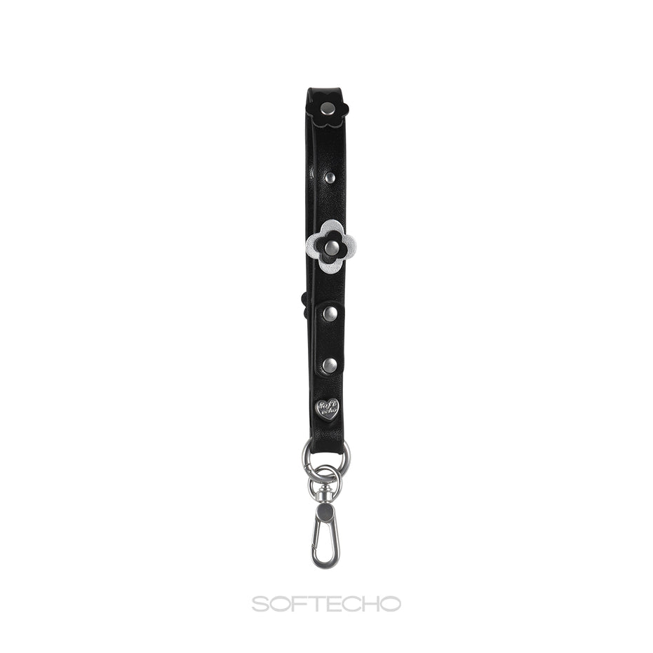 Black leather strap with silver flower charm and hardware on a white background, branded 'SOFTECHO'.