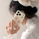Orchid Whisper iPhone case with layered floral petals and crystal accents