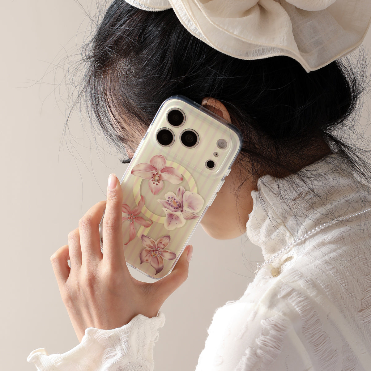 Orchid Whisper iPhone case with layered floral petals and crystal accents