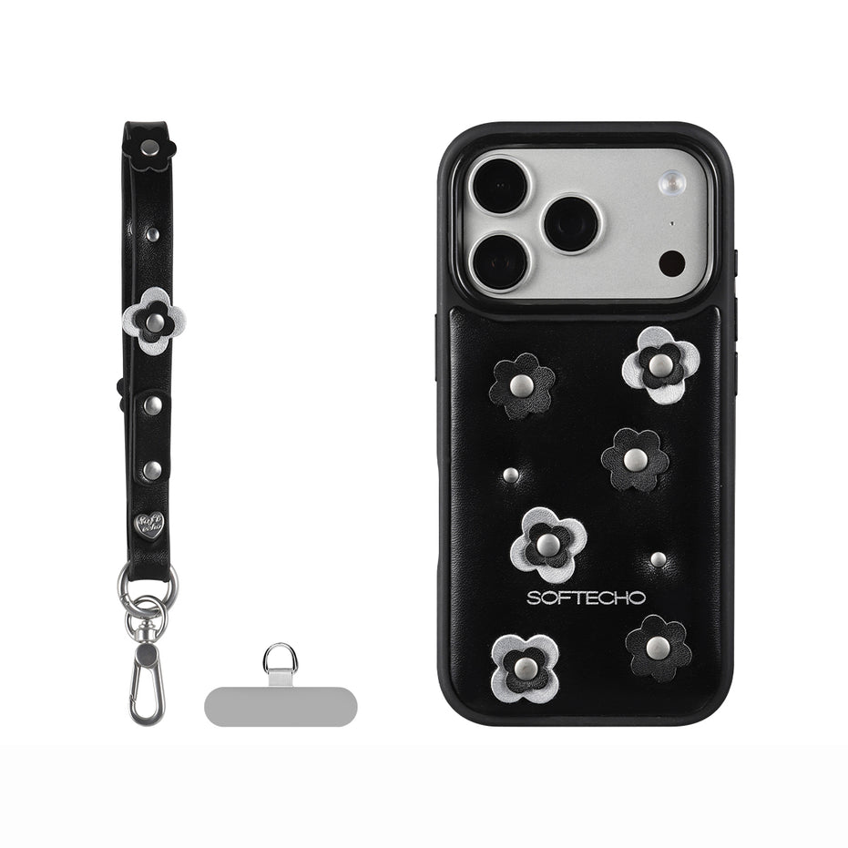 Black phone case with floral designs and accessories on a white background