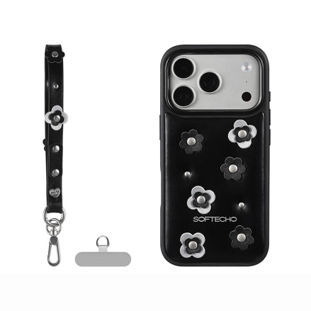 Black phone case with floral designs and accessories on a white background
